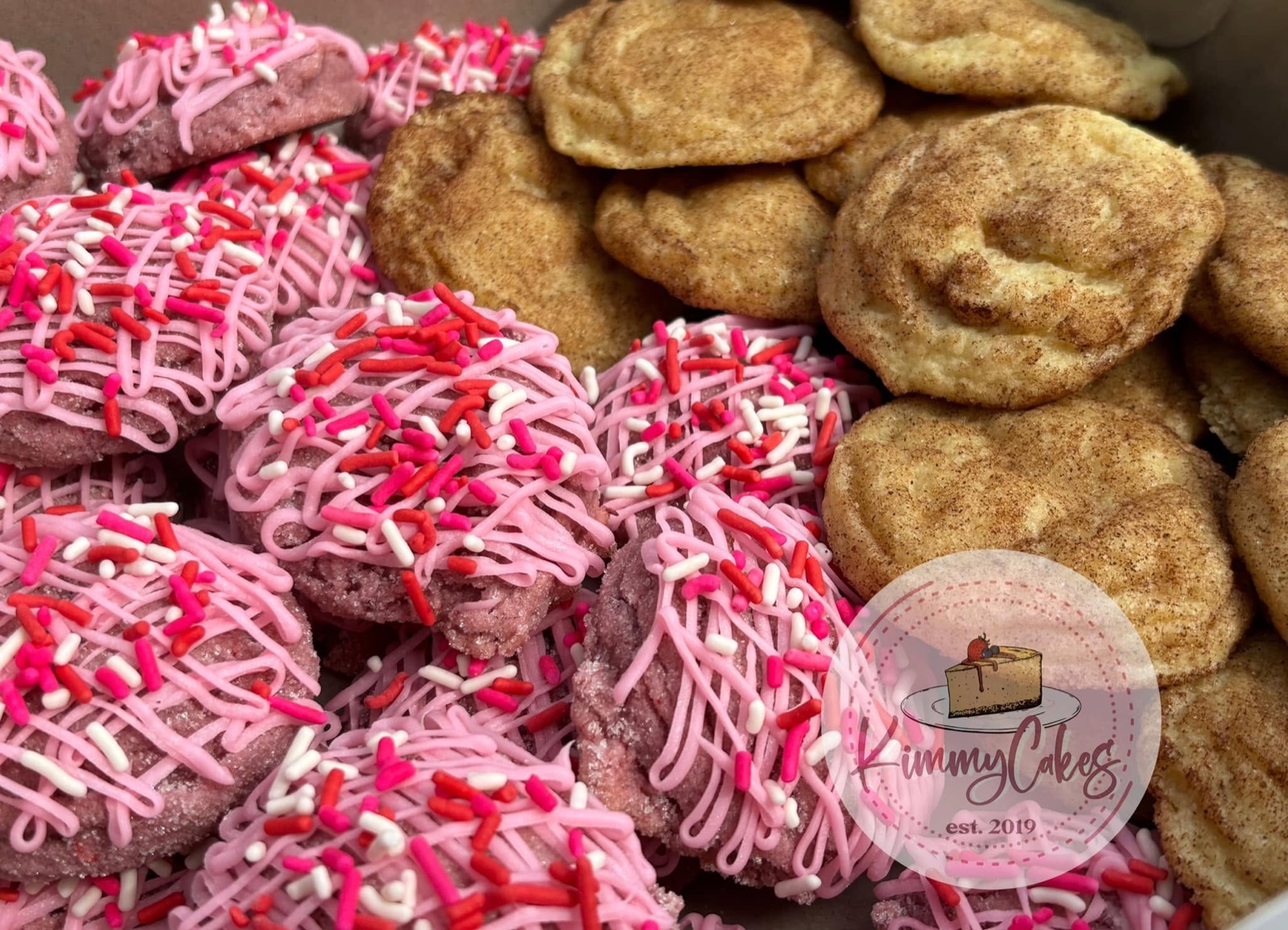 Pink drizzled cookies beside snickerdoodles